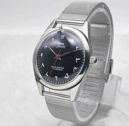 HMT Janata Handwinding Men's Watch with Black Dial Arabic Font and Transparent Back, 17 Jewels